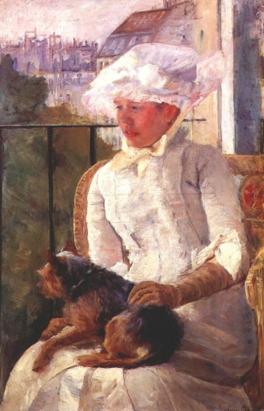 Susan on a balcony holding a dog